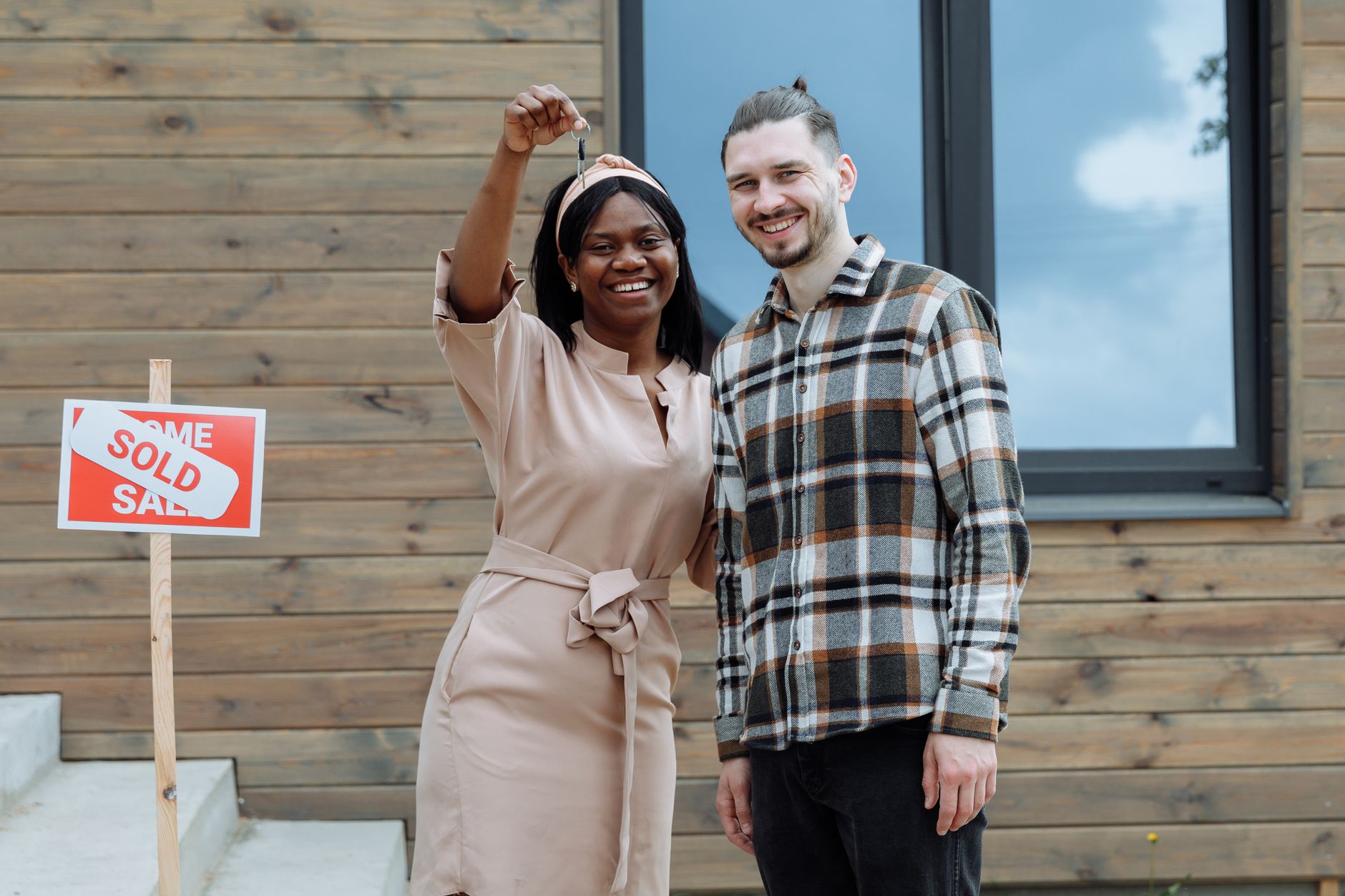 Homebuyer holding the key to her new home